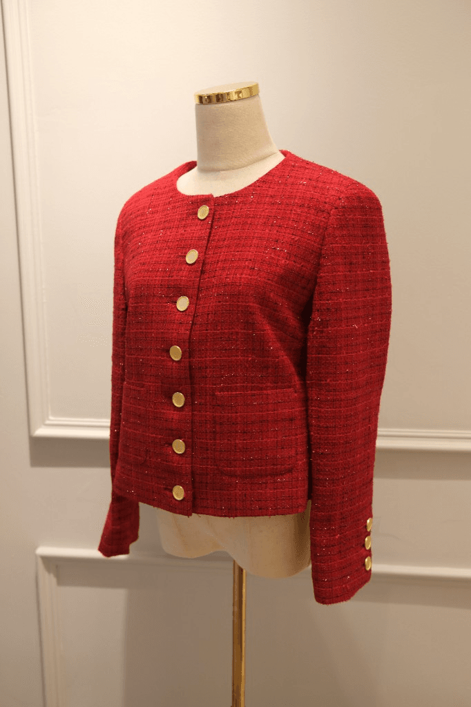 Red tweed collarless women's jacket with gold buttons on mannequin