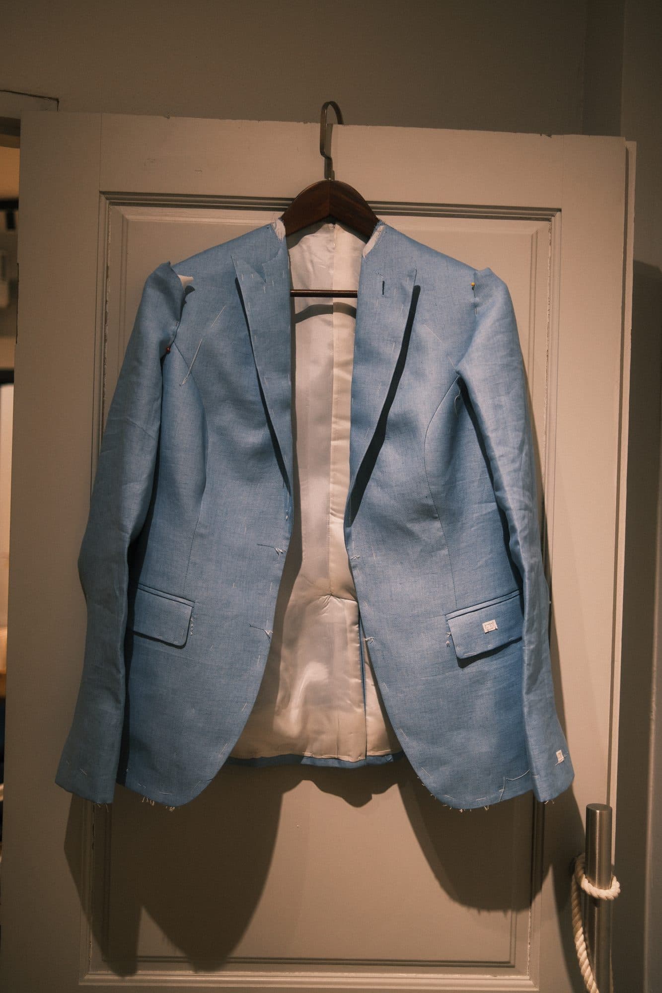 Half-constructed blue linen blazer showing the inner canvas