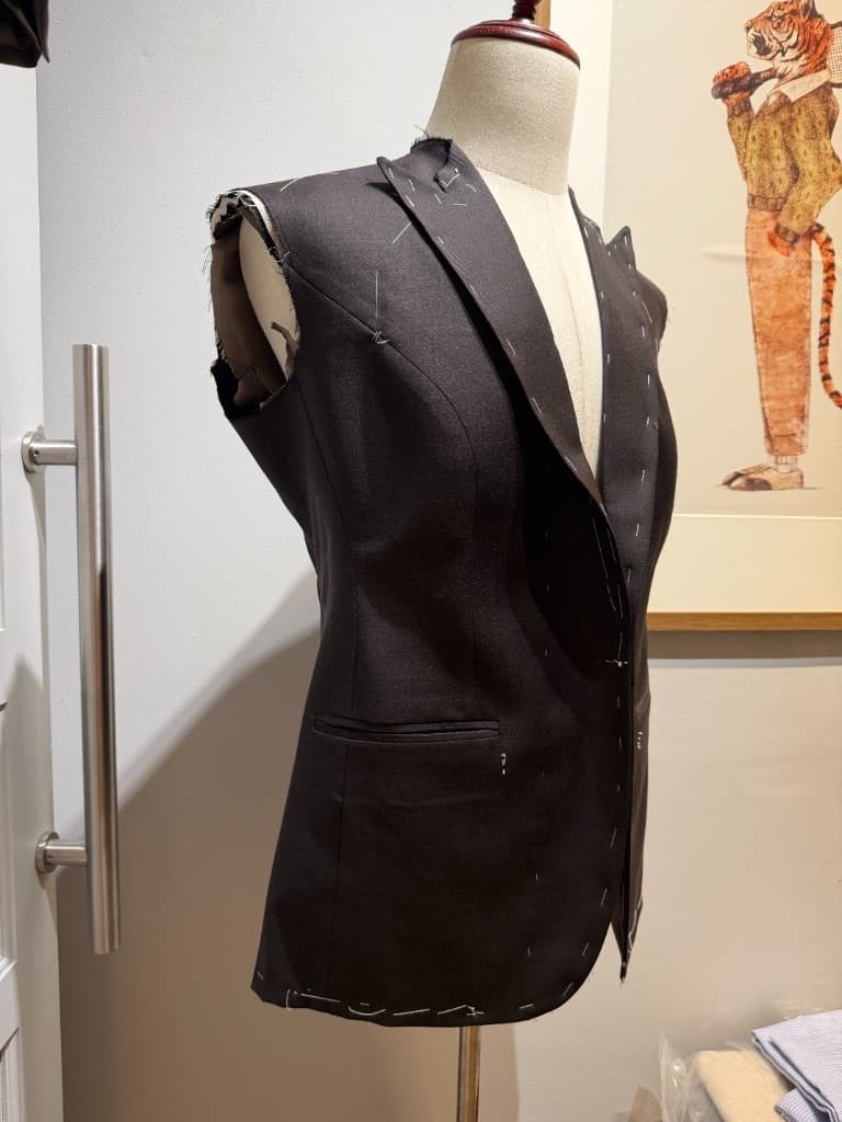 Women's suit basted on a mannequin during construction