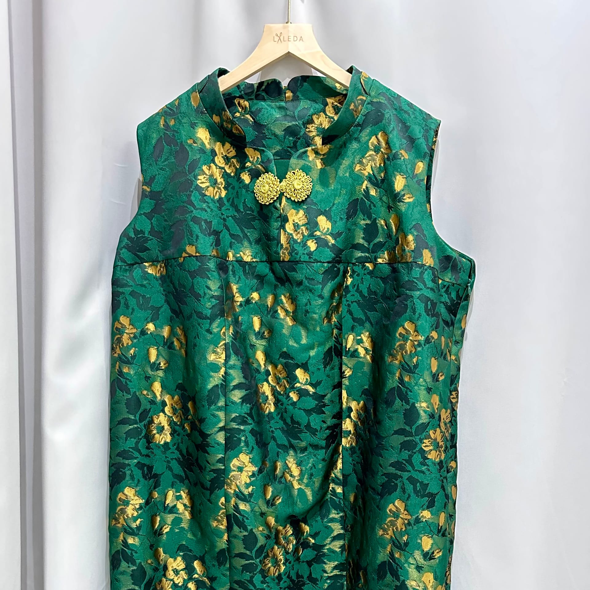 Green and gold floral mandarin-collar sleeveless dress on a LALEDA hanger