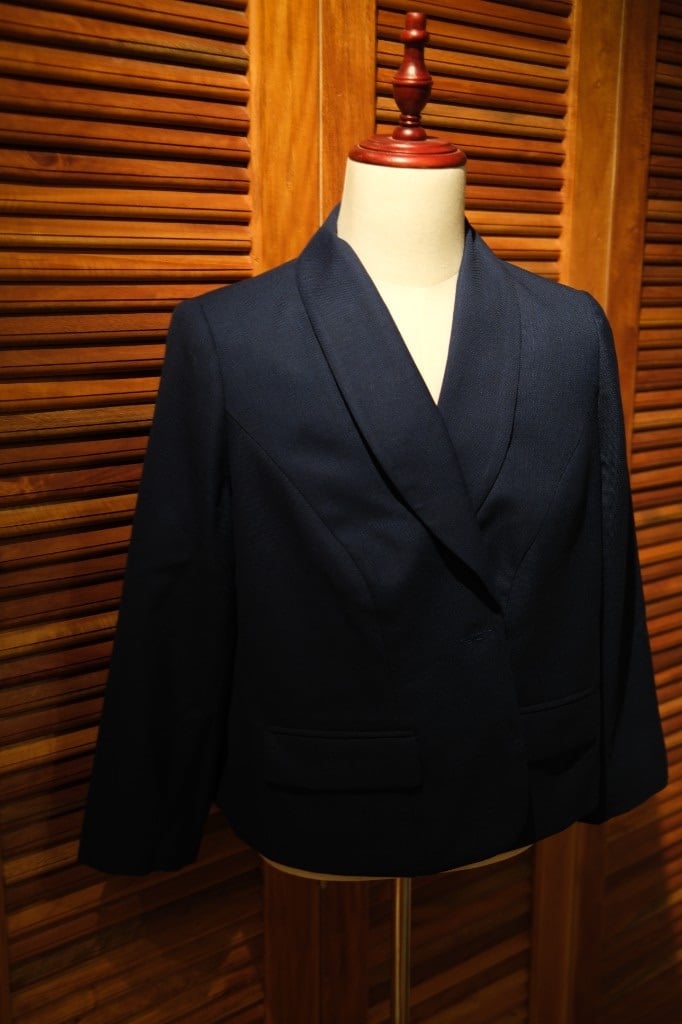 Navy blue women's blazer with shawl collar on a mannequin