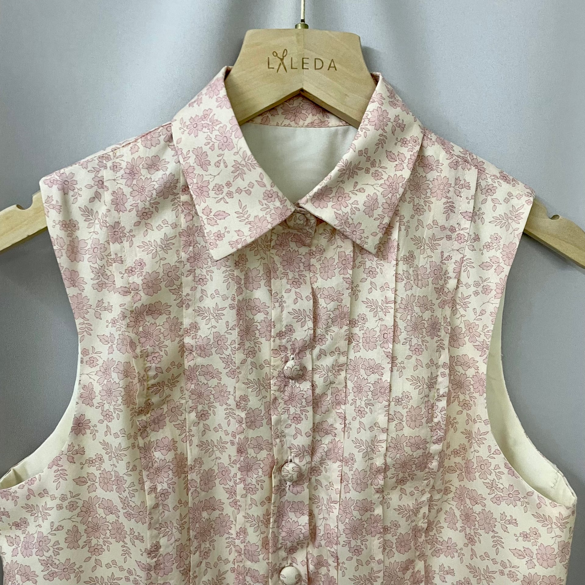 Pink floral sleeveless blouse with vintage print