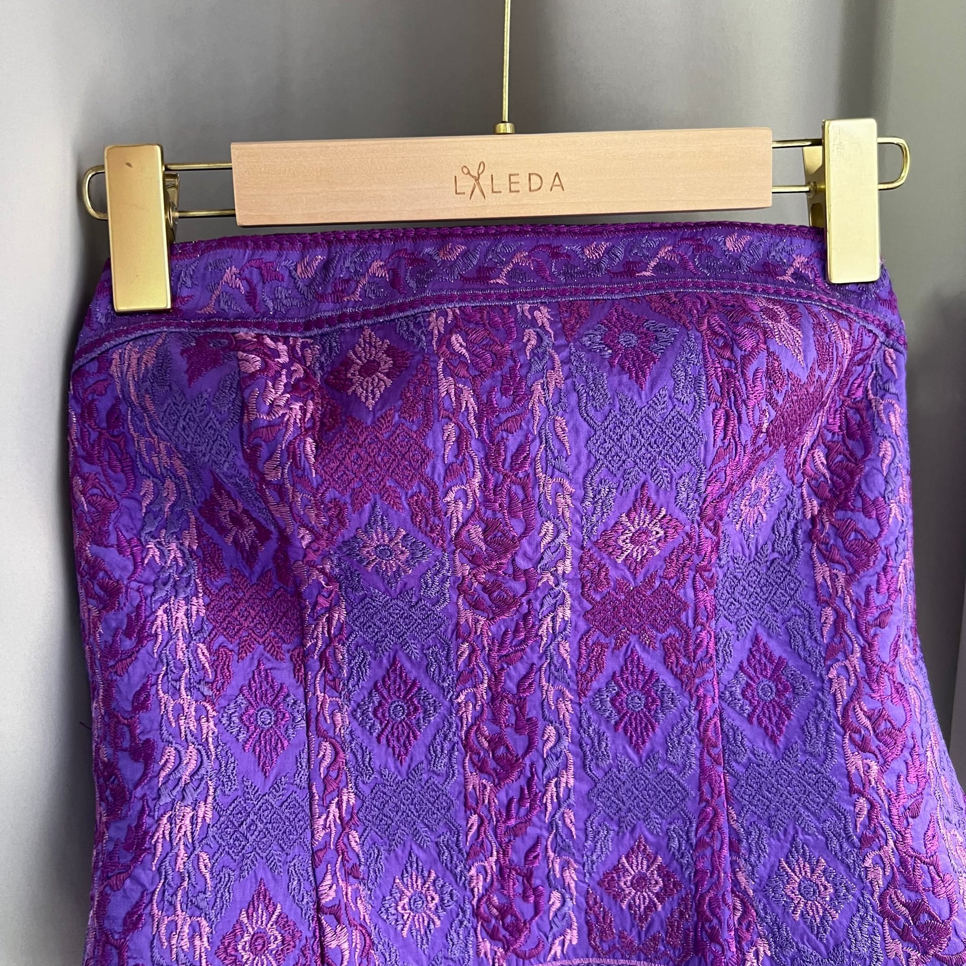Purple embroidered brocade pencil skirt on a LALEDA hanger