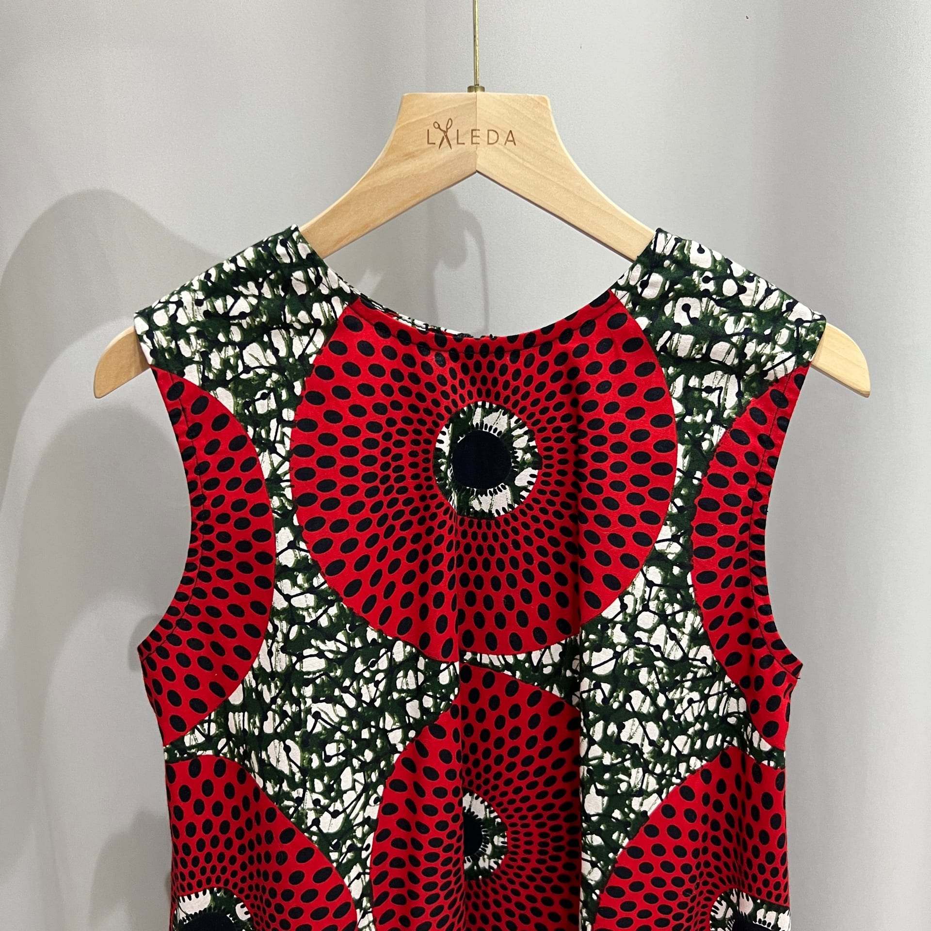 Red circle print sleeveless dress on a LALEDA hanger