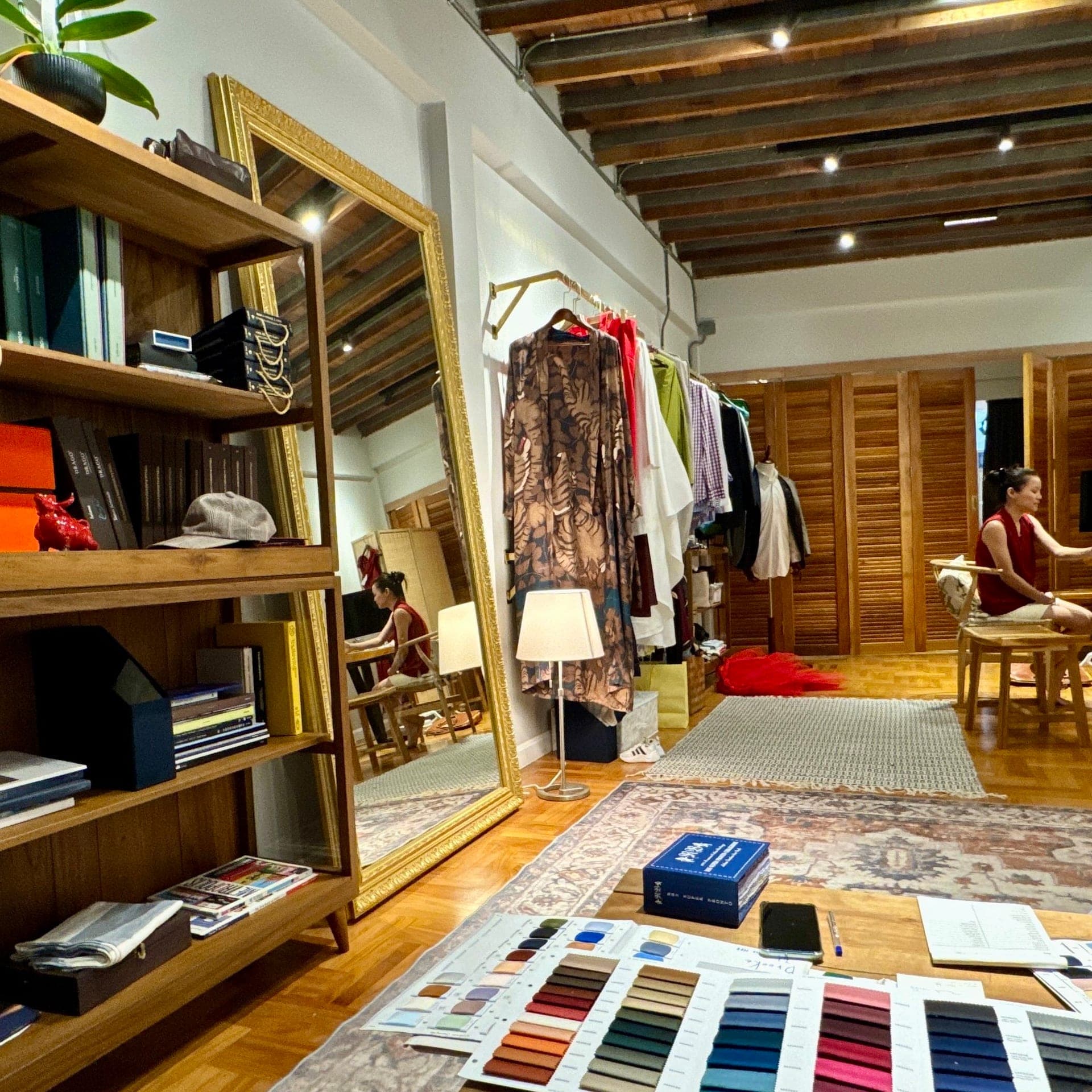 Inside the LALEDA atelier with fabric swatches laid out for a consultation