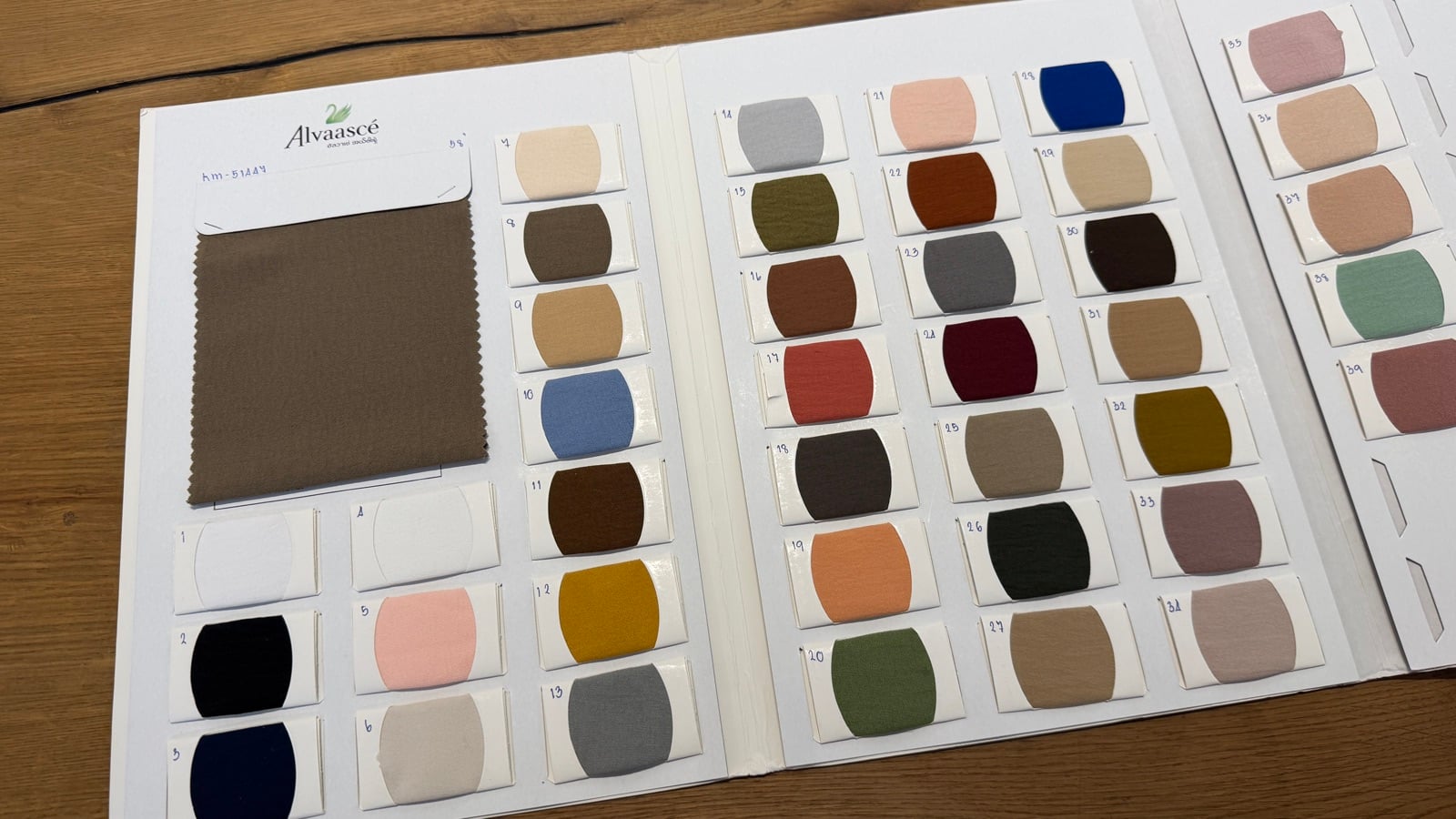 Bella fabric colour swatch book with a taupe sample and the full range of numbered shades