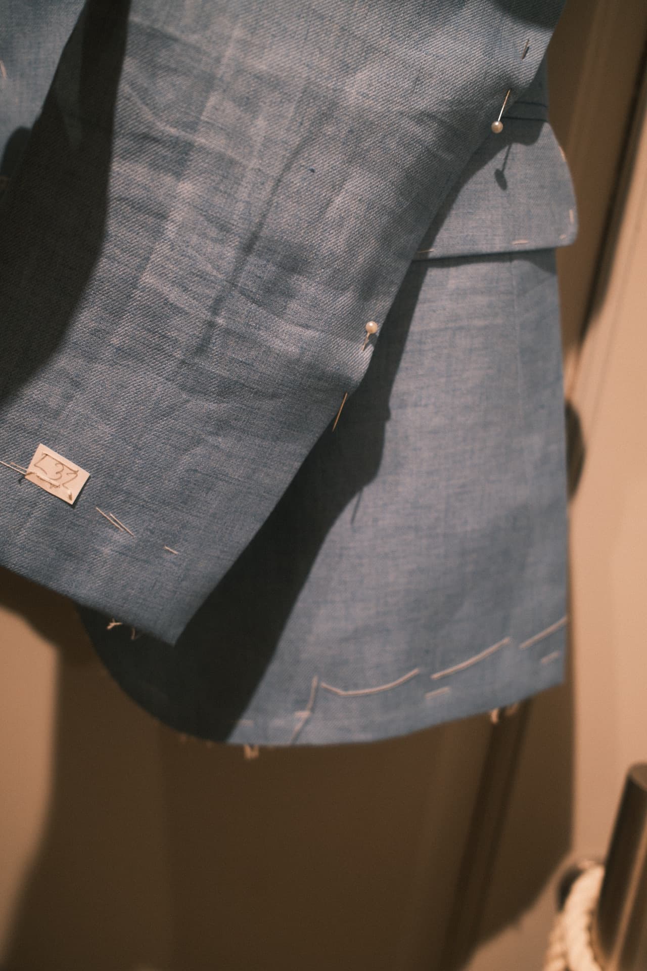Sleeve and cuff detail on a blue linen tailored jacket