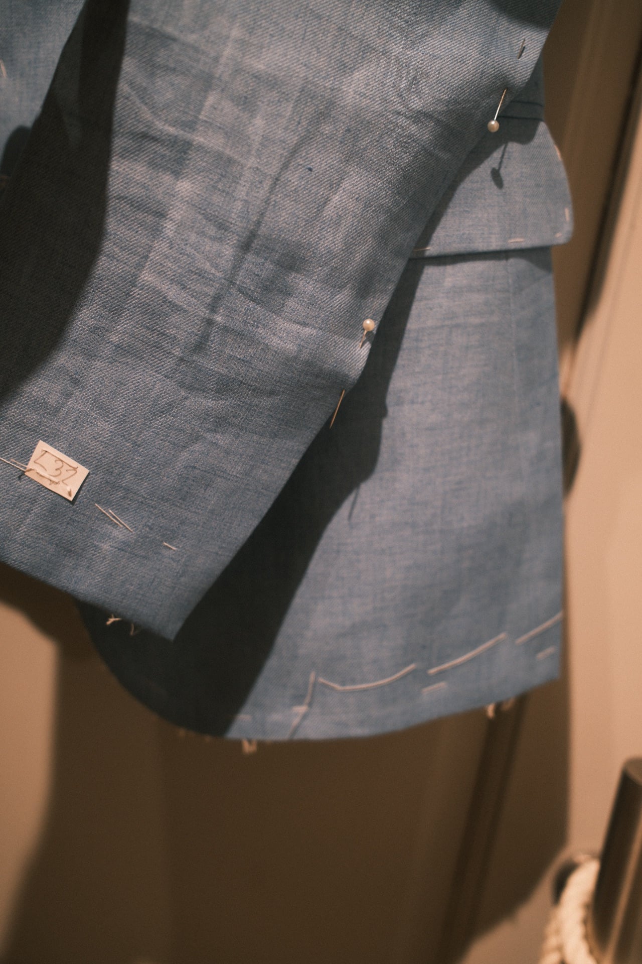 Sleeve and cuff detail on a blue linen tailored jacket