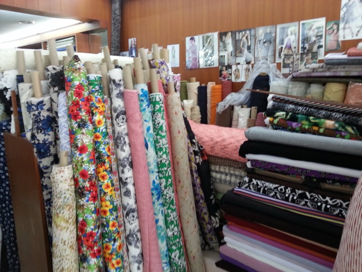Bolts of printed and floral fabric inside Brooke's Fabrics, Bangkok