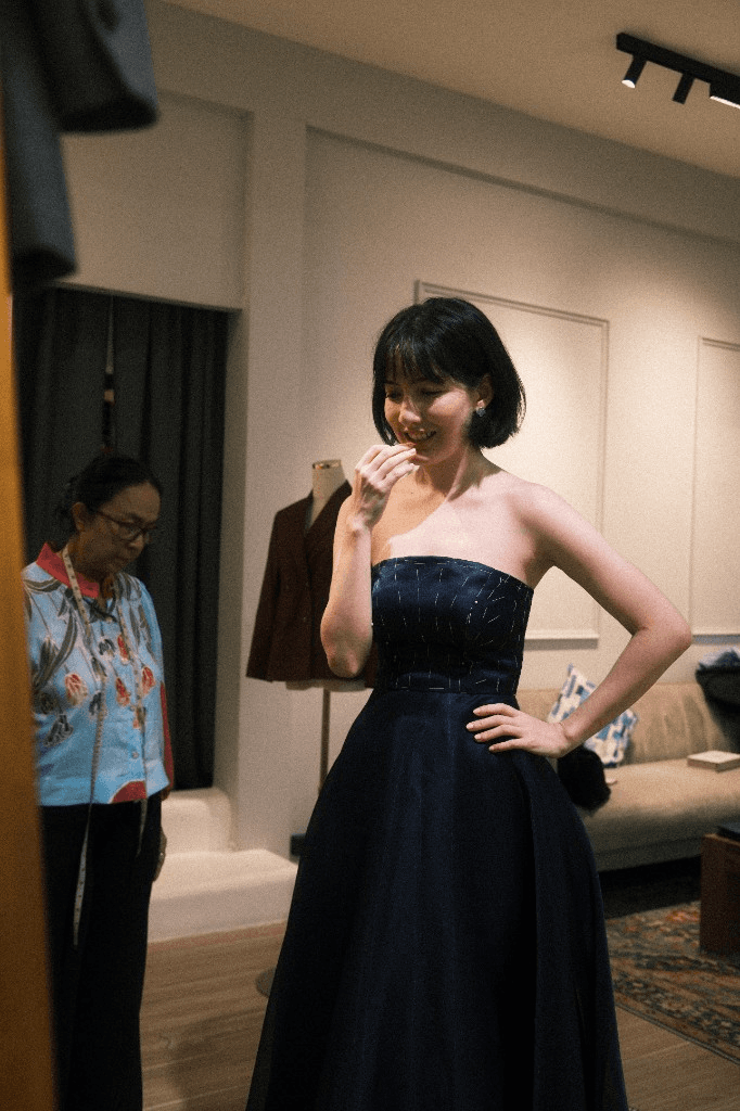 Dark blue strapless gown at fitting