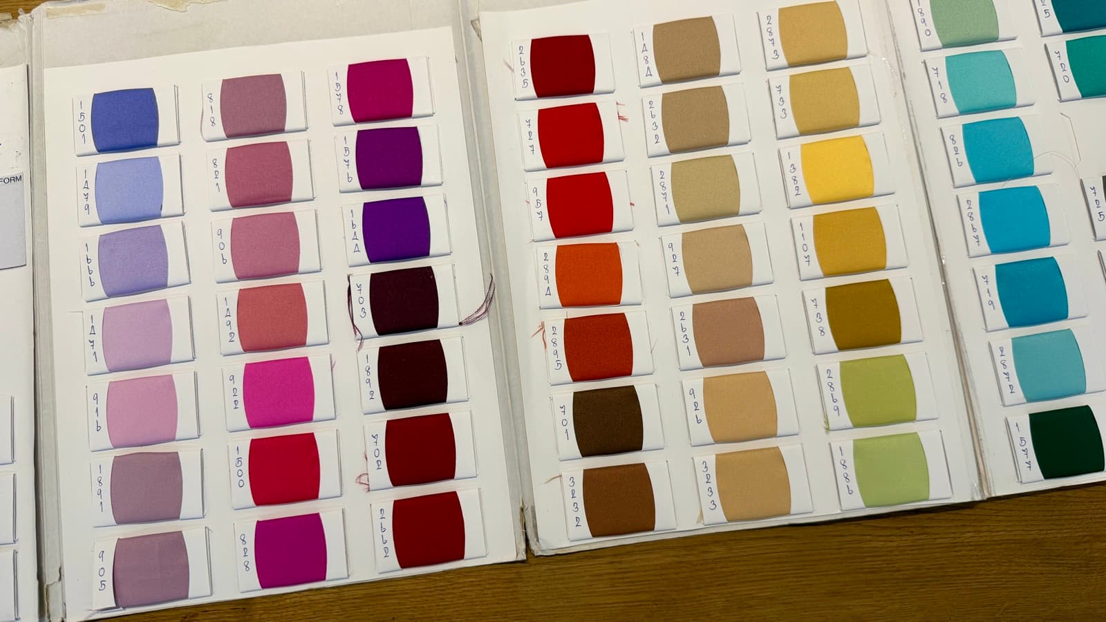Duchess satin swatch books open on the atelier table