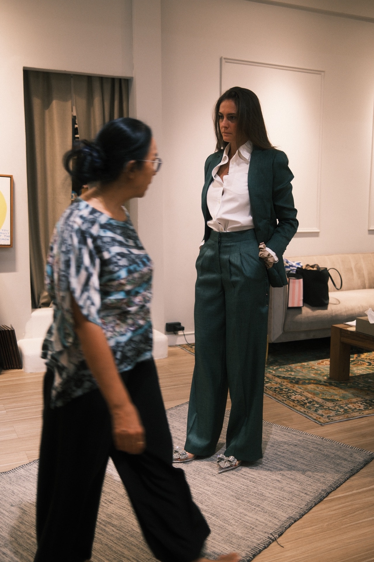 Customer in an emerald green women's suit at a LALEDA fitting