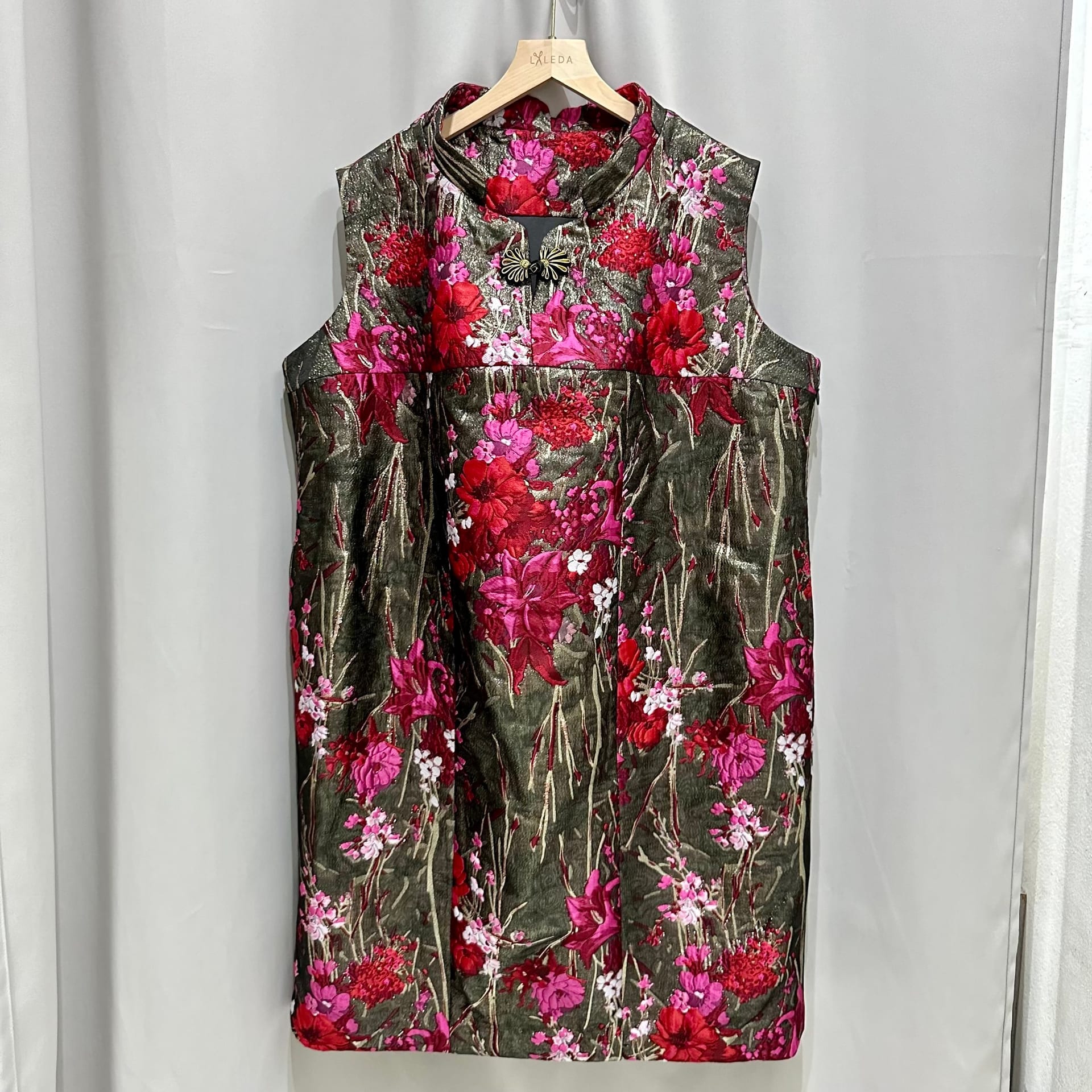 Sleeveless shift dress in olive brocade with pink and red floral embroidery on a LALEDA hanger