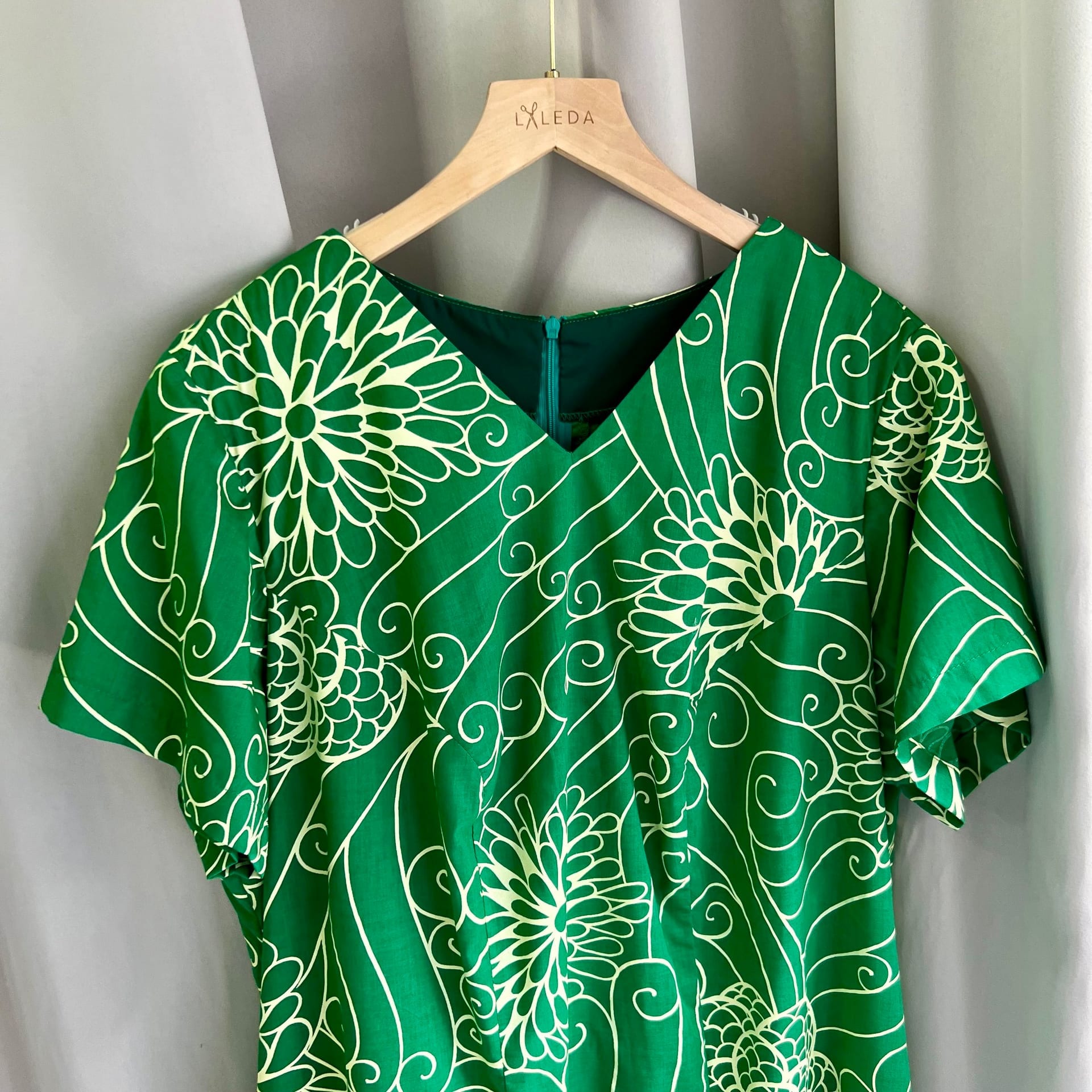 Green blouse with delicate floral embroidery on a LALEDA hanger