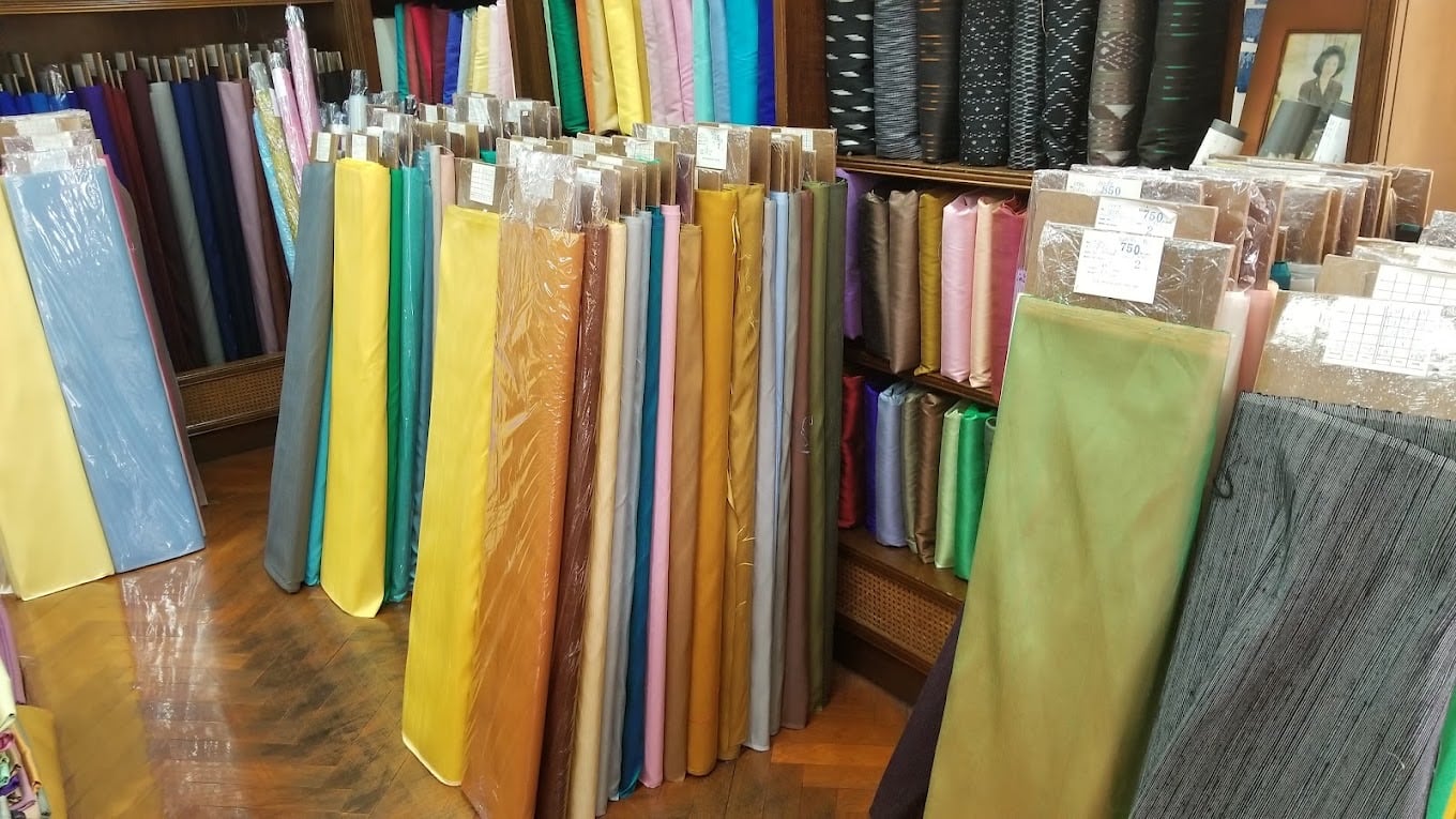 Rows of silk bolts in a range of colours at H.M. Factory for Thai Silk