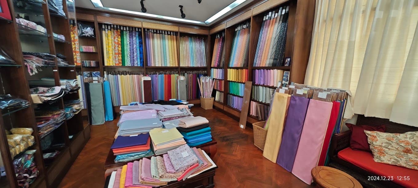 Shelves of colourful silk bolts at H.M. Factory for Thai Silk