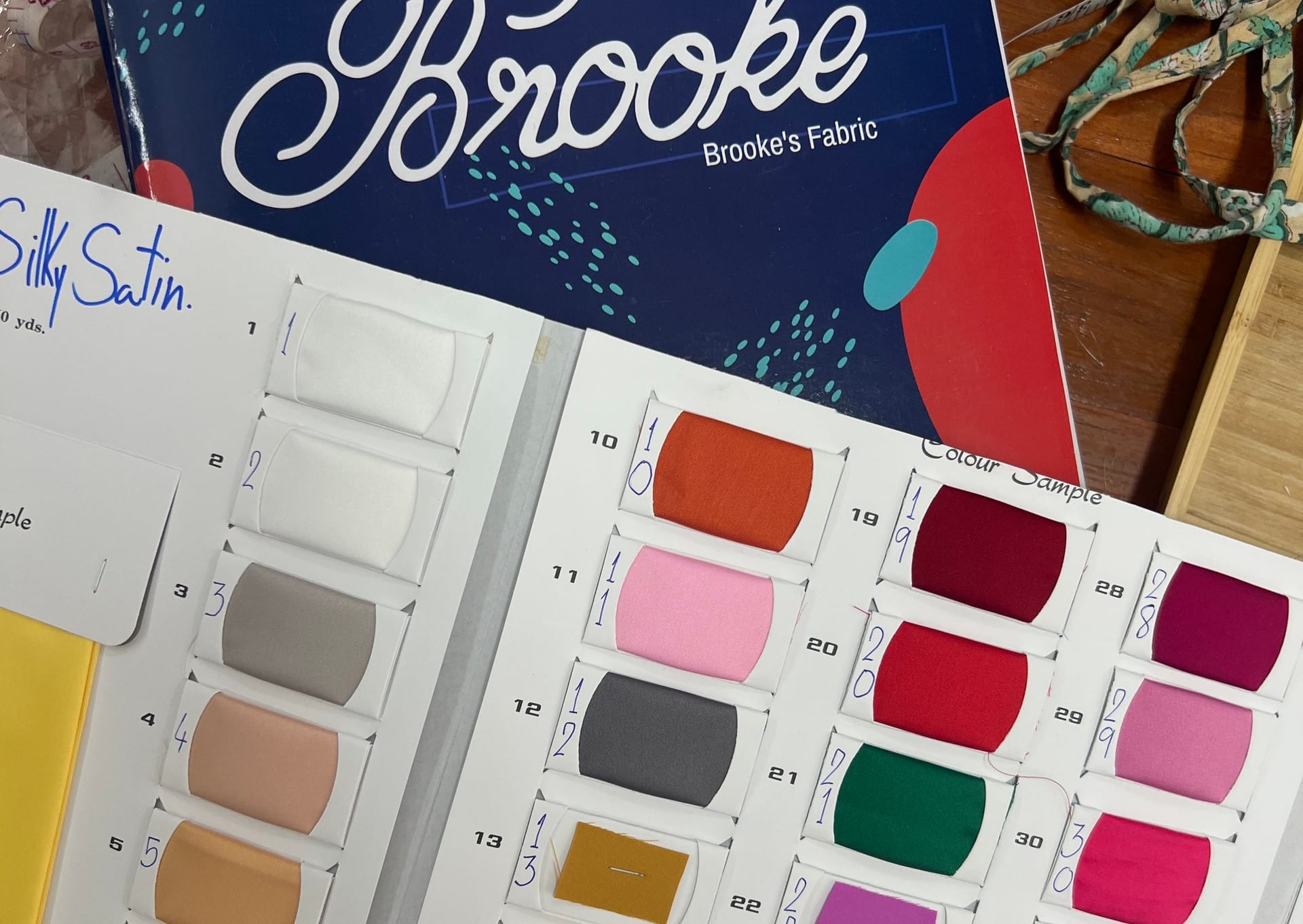 A Brooke's Fabrics colour swatch book of silky satin shades