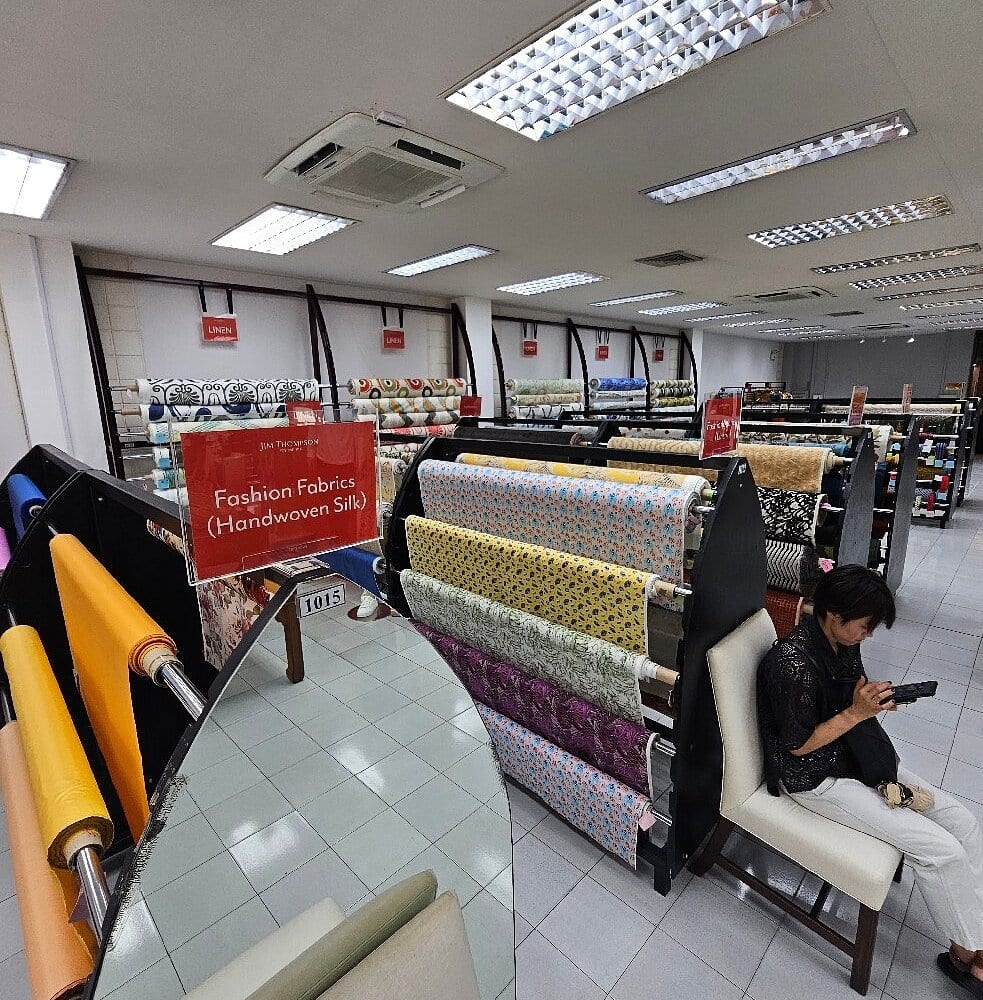 Interior of the Jim Thompson factory outlet showing rolls of silk