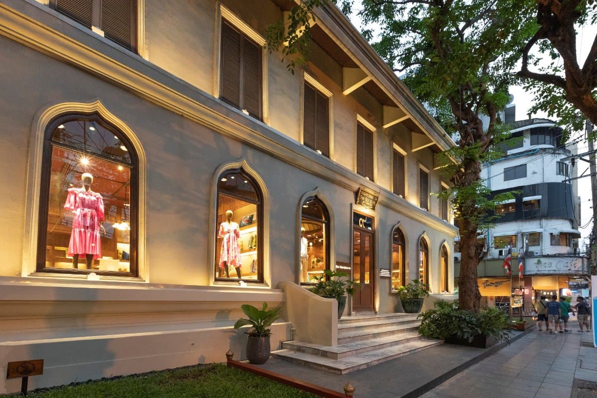 Jim Thompson Surawong main store exterior at dusk with lit window displays