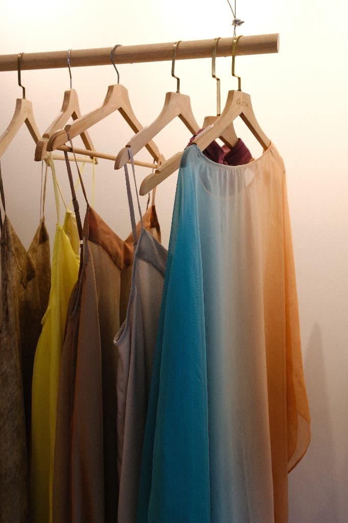 Lightweight flowing dresses and camisoles on hangers at LALEDA Tailor