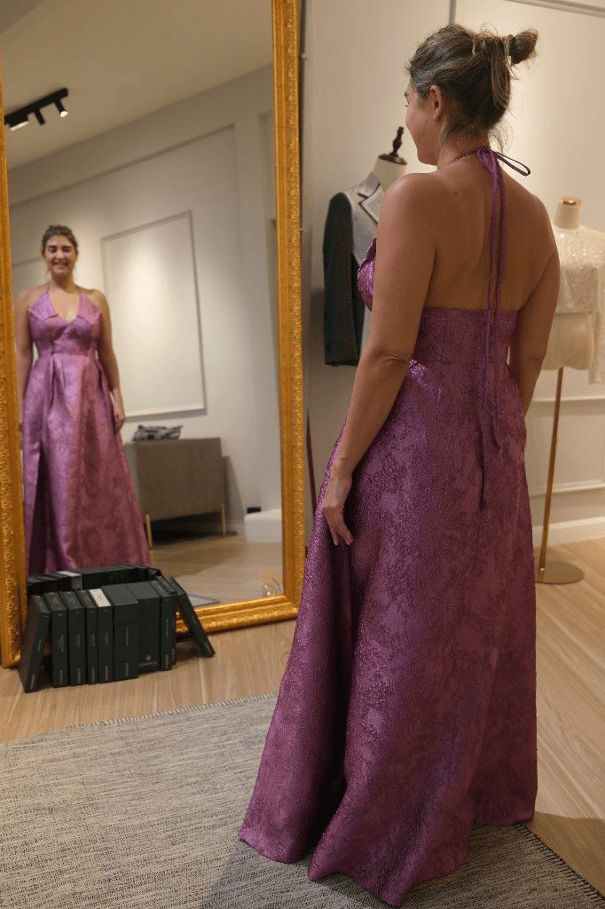 Magenta brocade halter gown at fitting