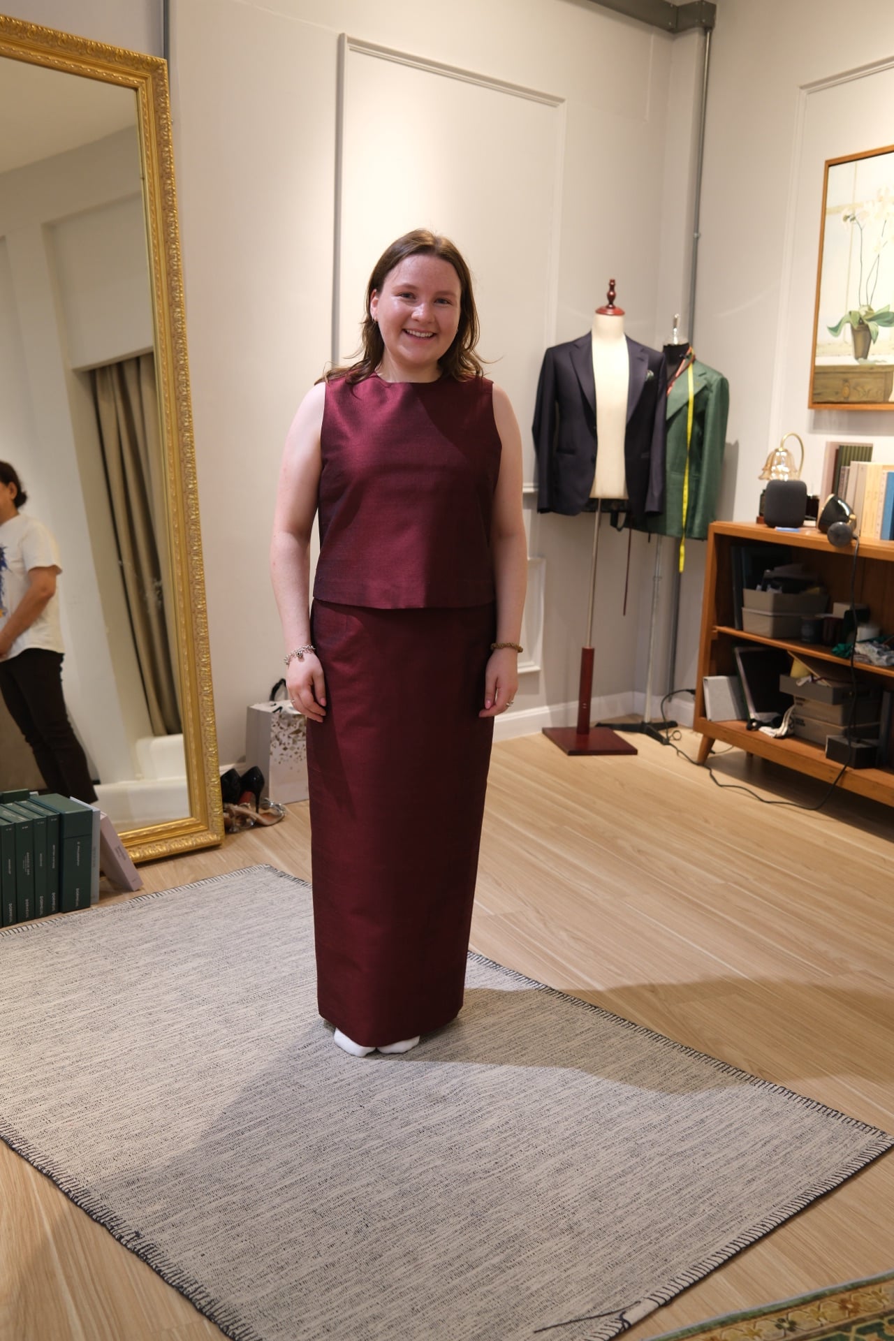 Customer wearing a custom maroon Thai silk dress at LALEDA