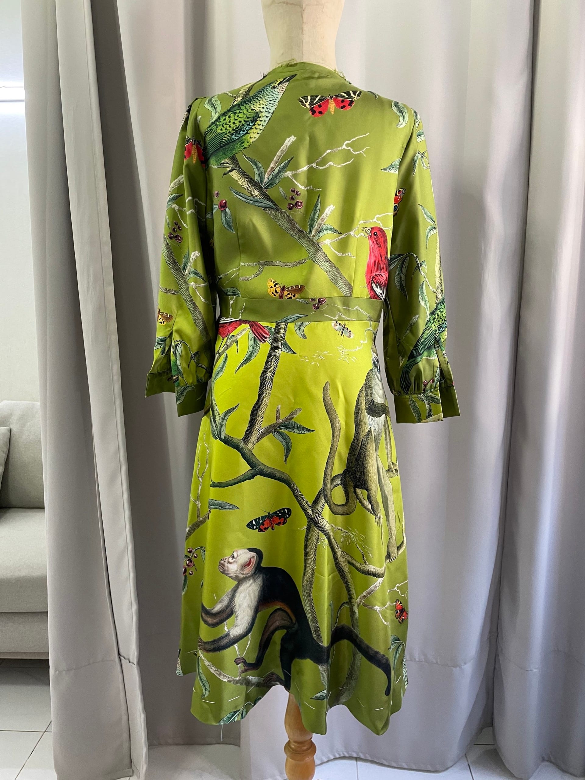 Olive green silk dress with bird embroidery, viewed from the back