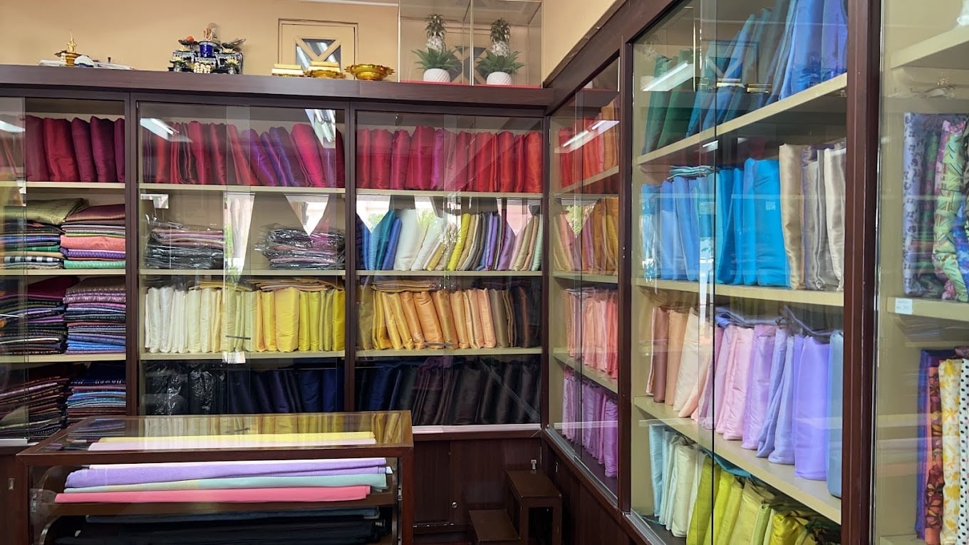 Colourful silk bolts on shelves at Phanthip Thai Silk Bangkok