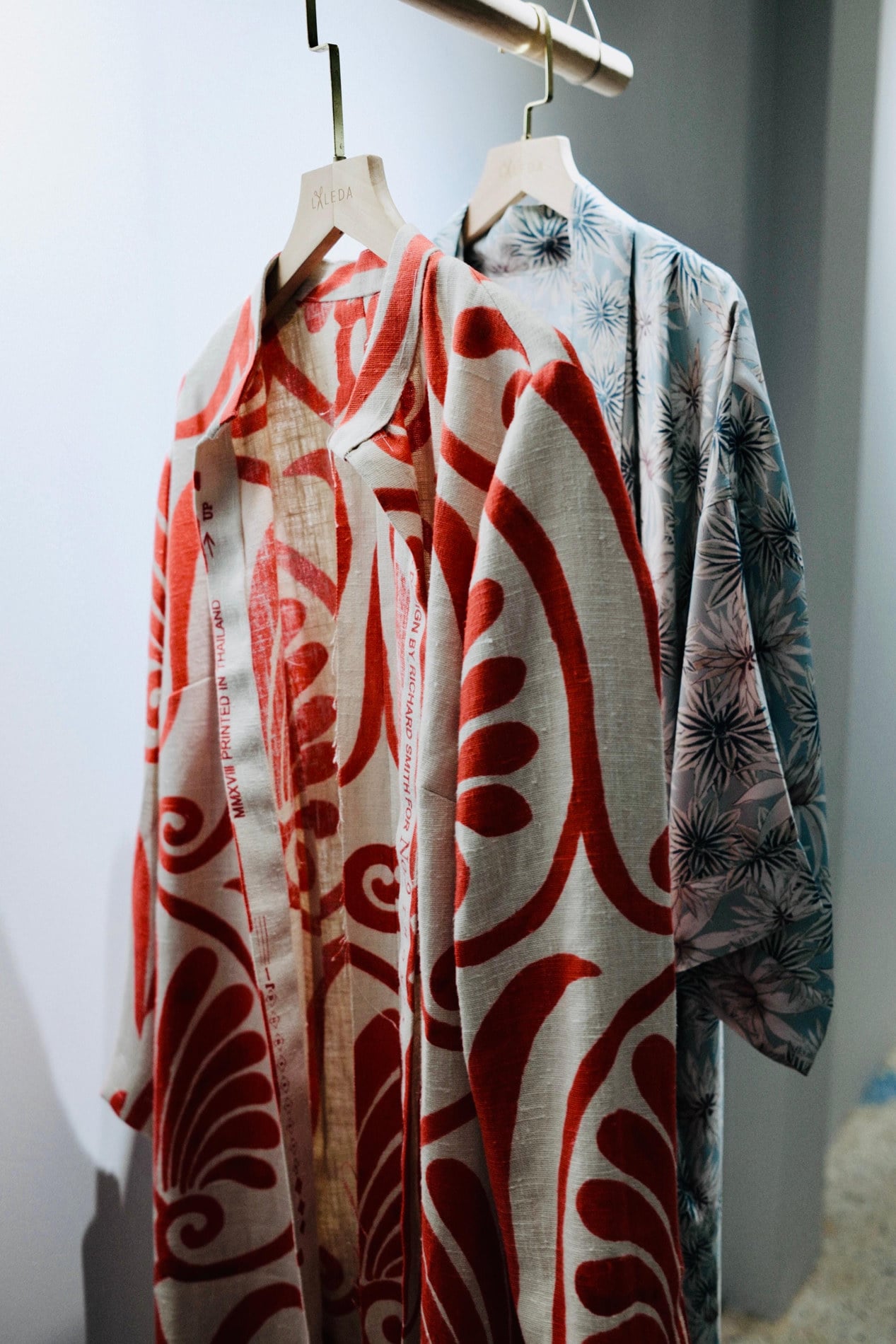 Printed linen shirts on LALEDA hangers showing Thai and Liberty-style prints