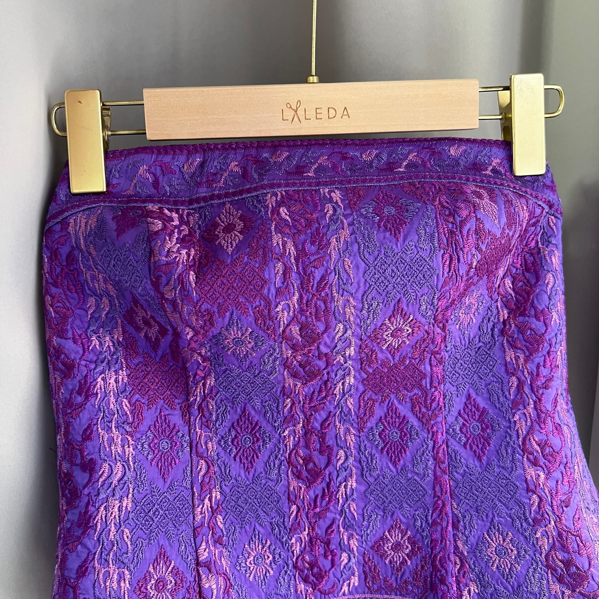 Purple embroidered brocade pencil skirt on a LALEDA hanger