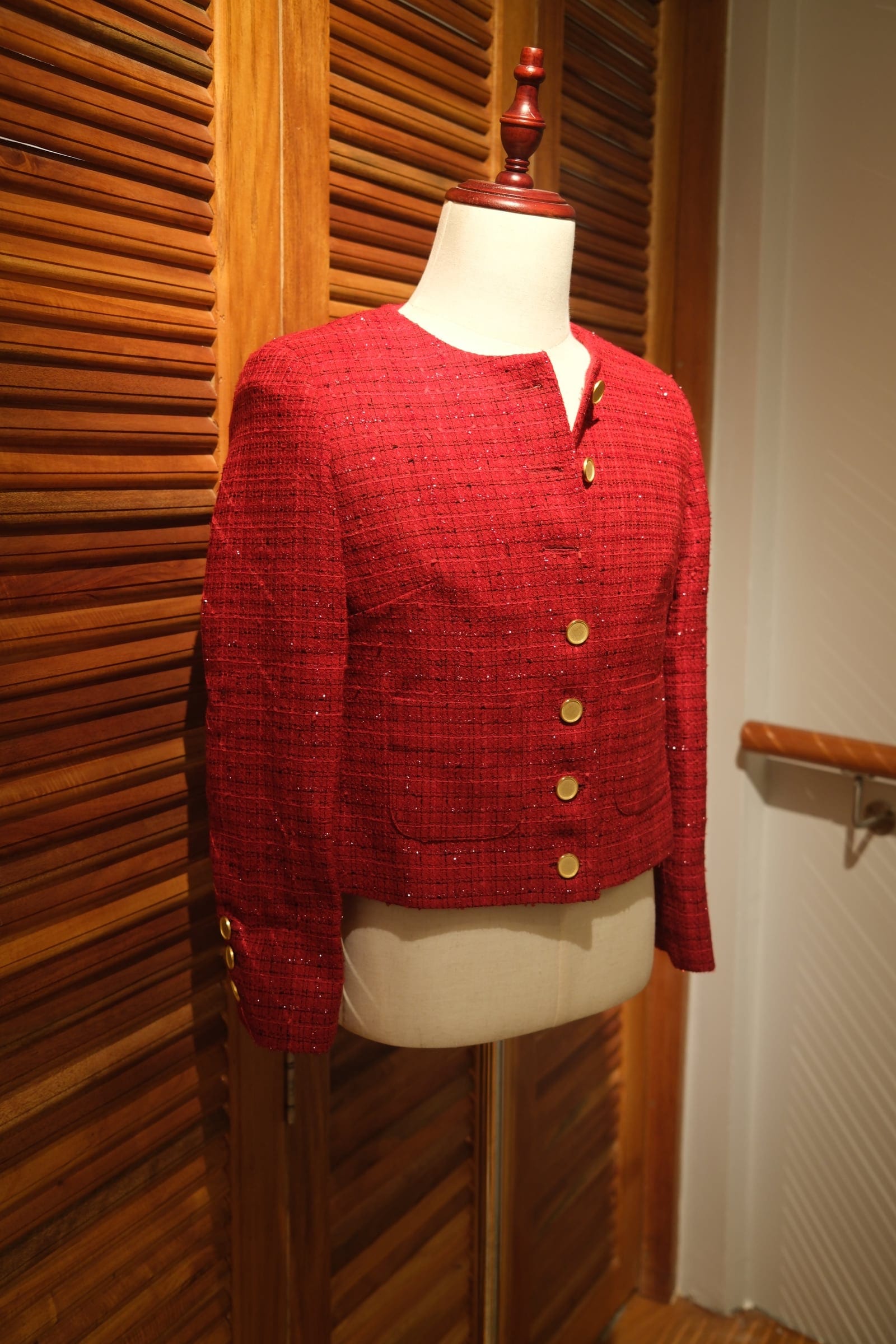 Red Chanel-style women's tailored jacket