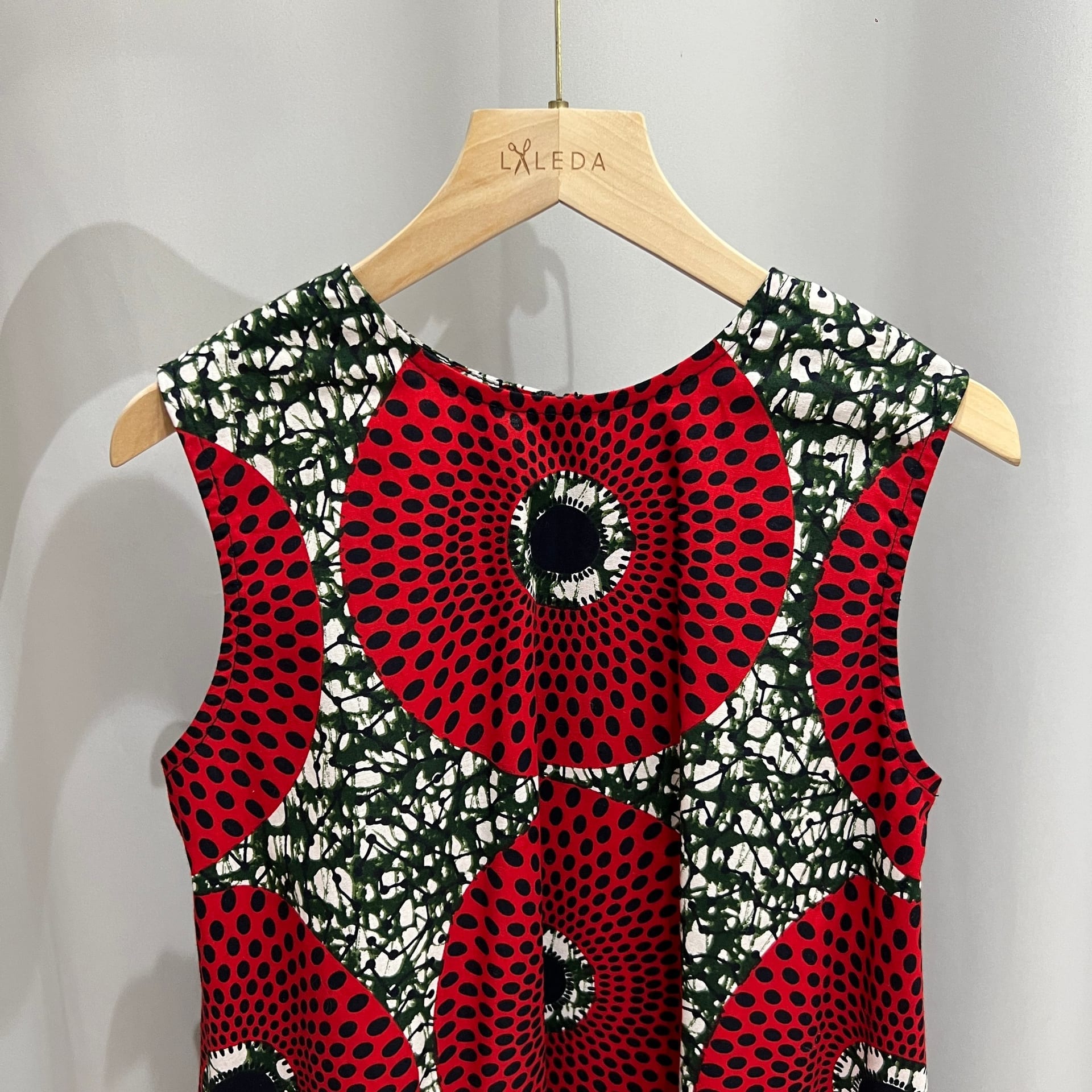Red circle print sleeveless dress on a LALEDA hanger