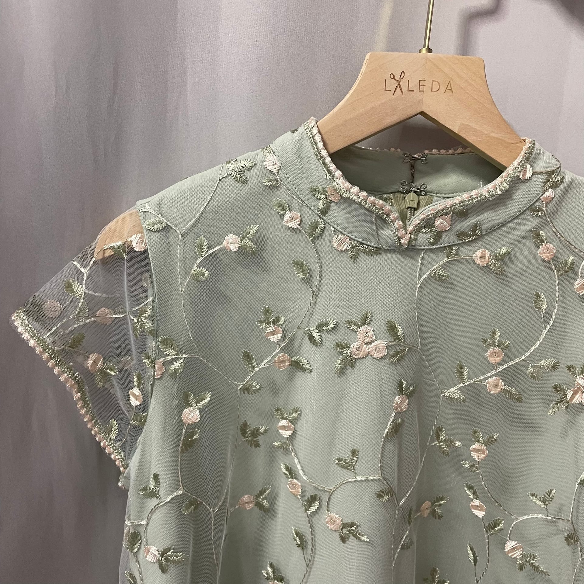 Sage green organza blouse with embroidered floral detail