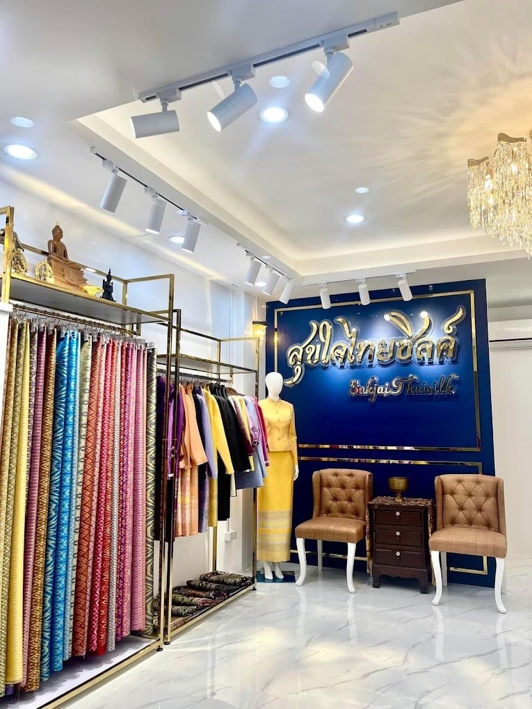 Sukjai Thaisilk interior with gold Thai sign and silk displays