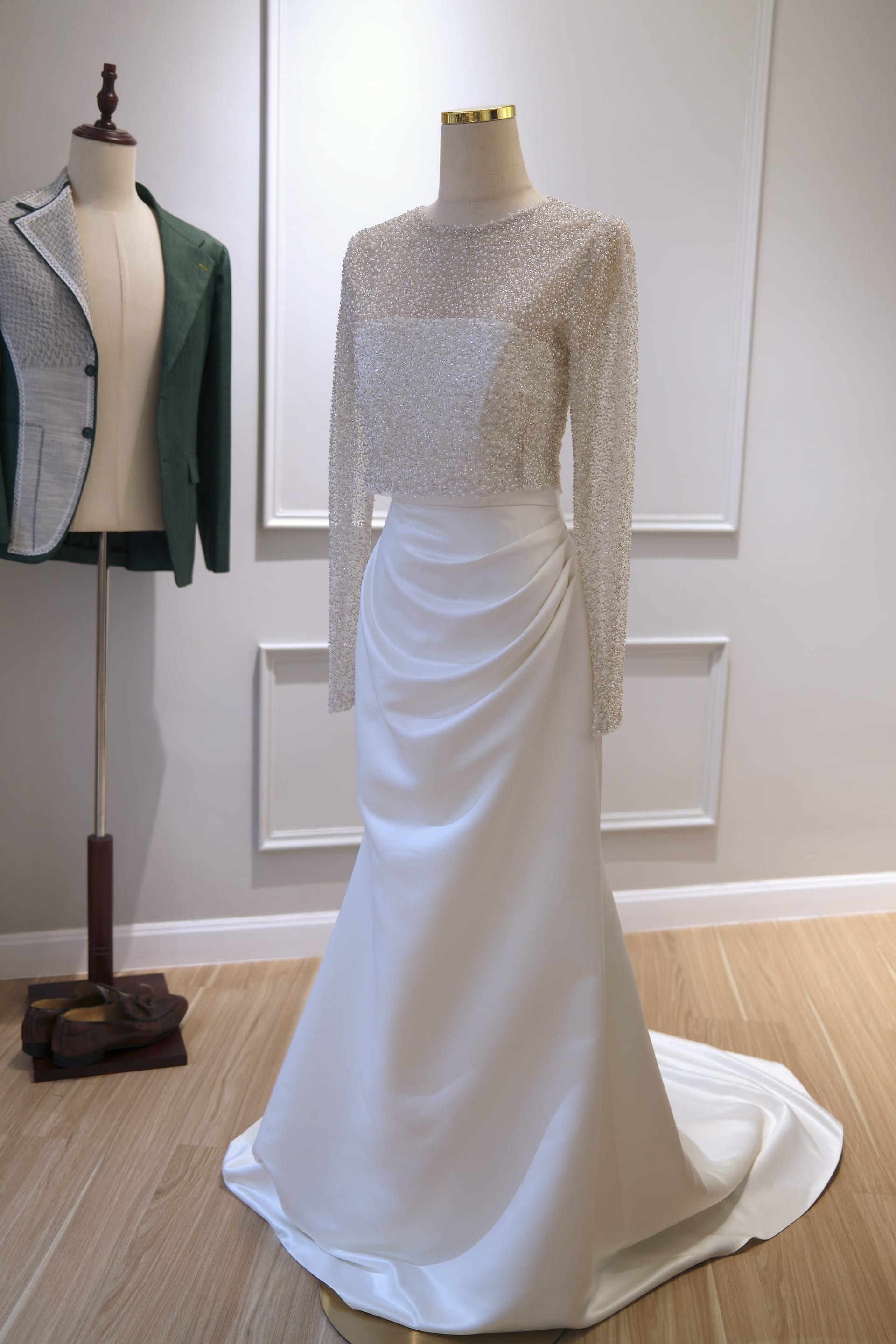 Ivory wedding gown with a hand-sewn pearl and crystal beaded bodice and draped satin skirt