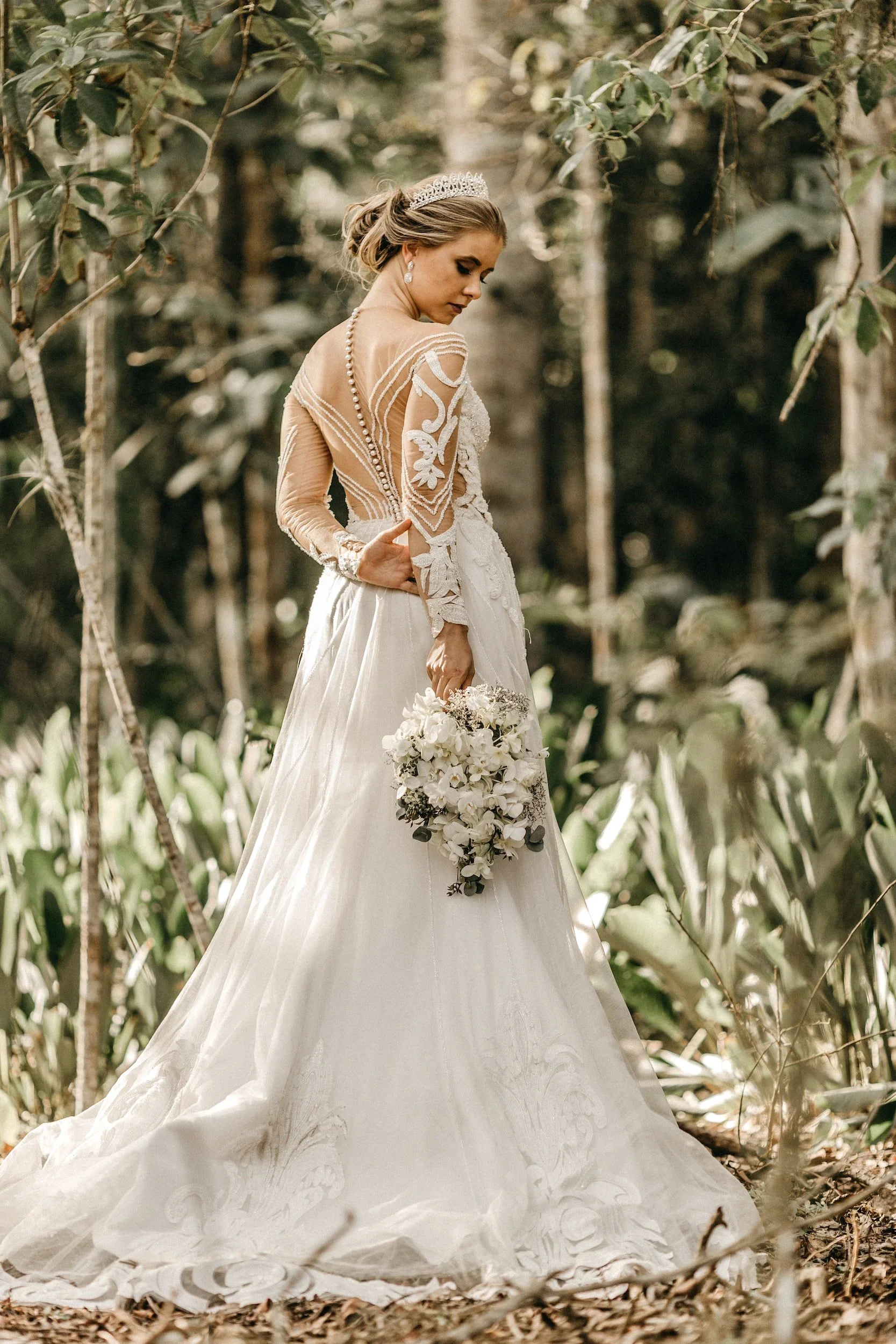 The LALEDA atelier: a tailor arranging the tulle train of a wedding dress
