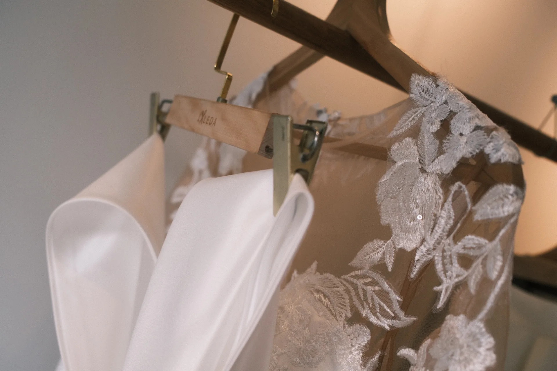 Lace wedding gown detail on a hanger at LALEDA atelier