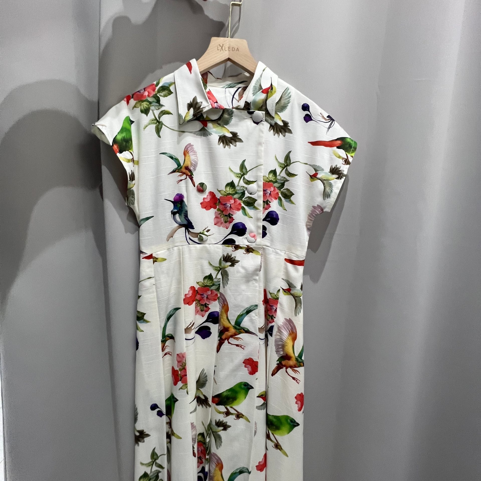 White bird and floral print dress with cap sleeves and button front