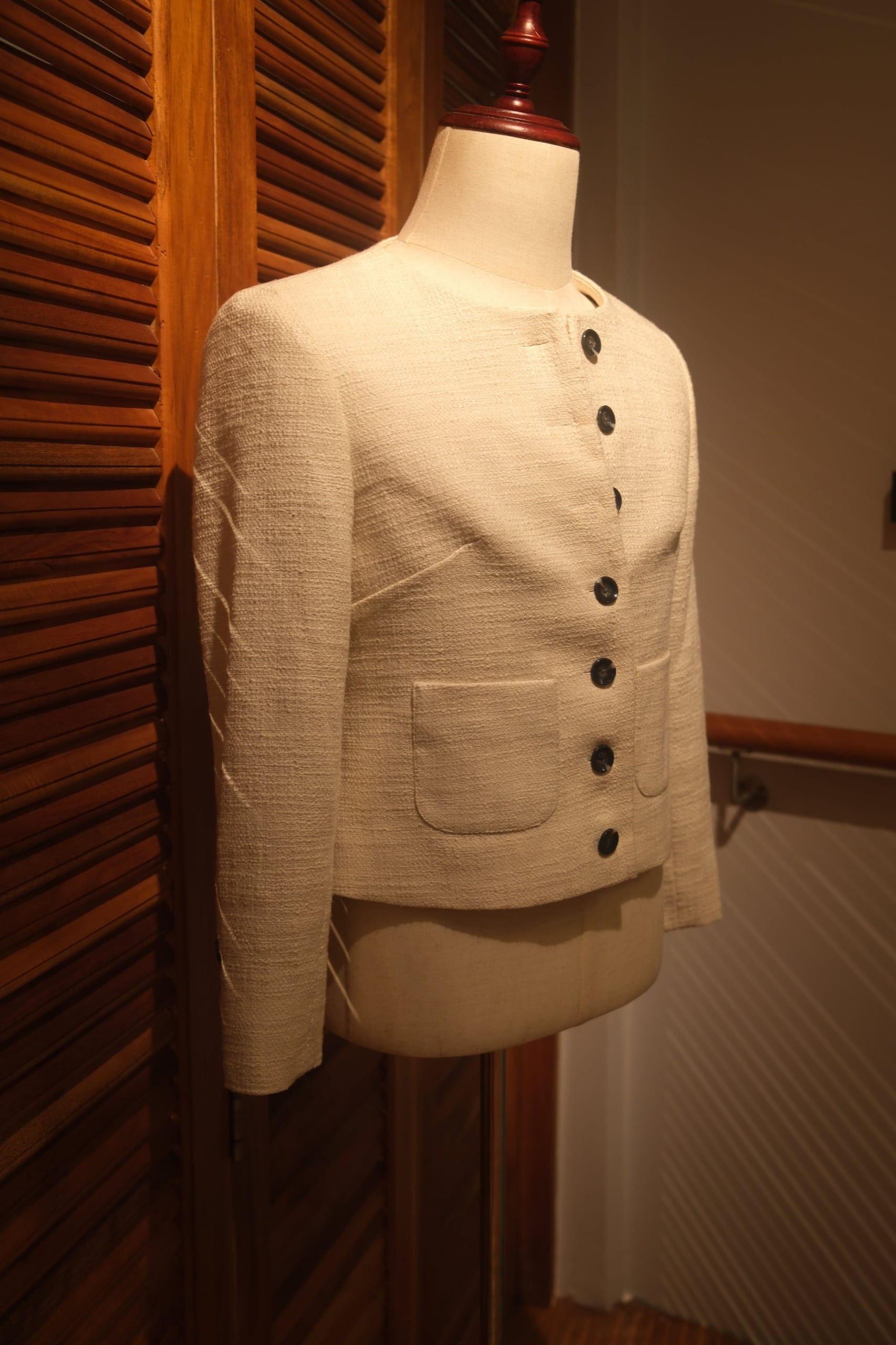 White Chanel-style women's tailored jacket