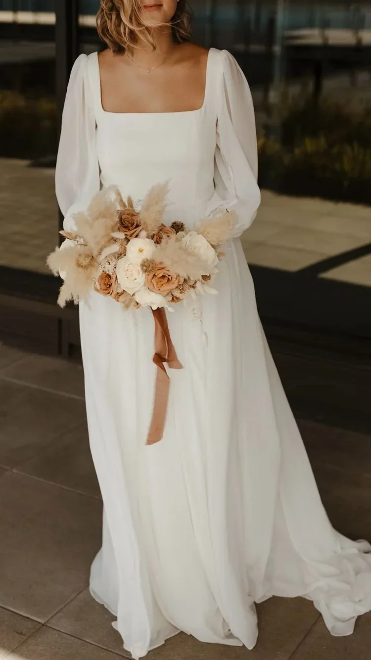 Bride in a white wedding dress with soft flowing details