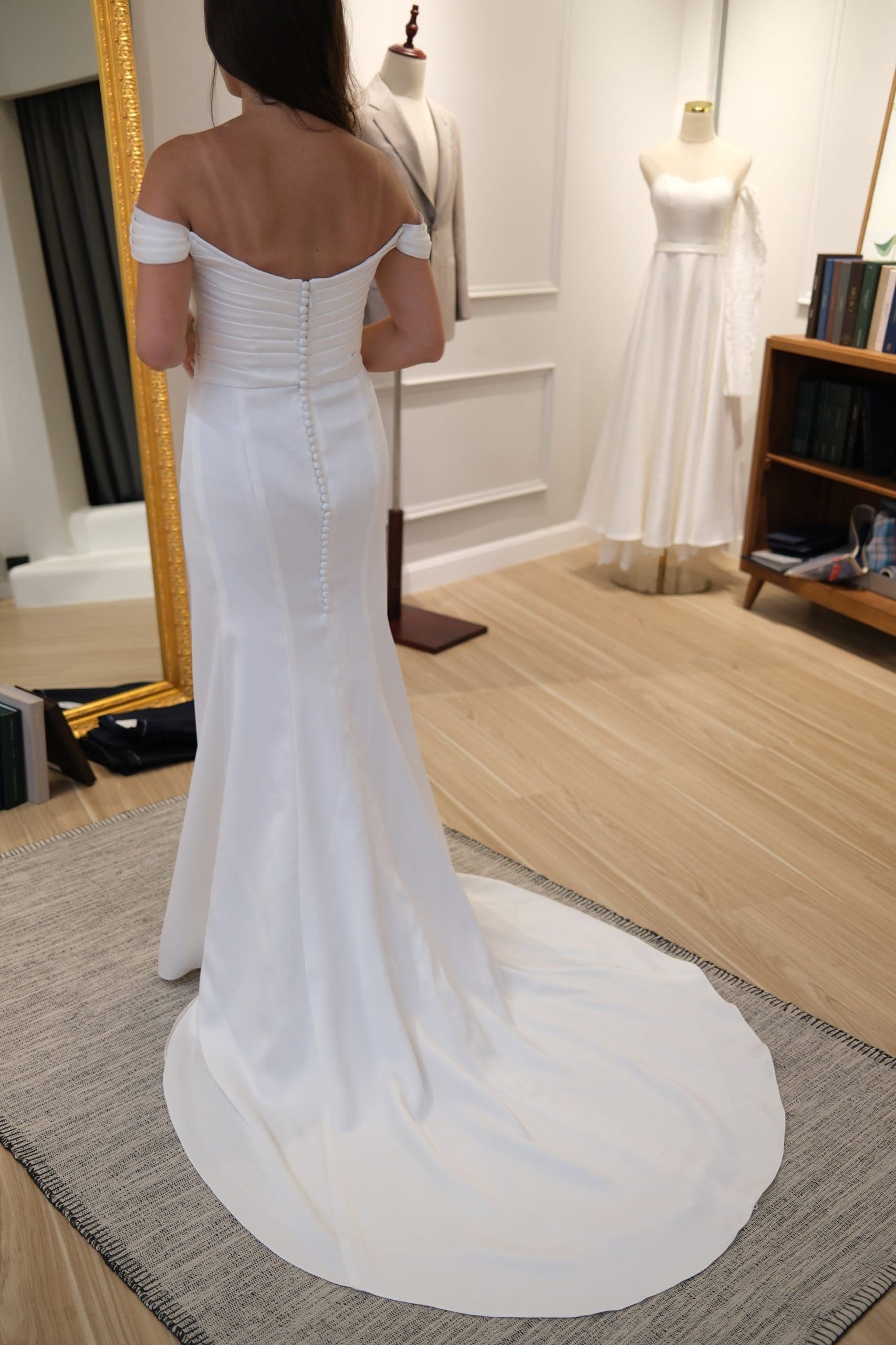 Back of a white wedding dress with a row of fabric covered buttons