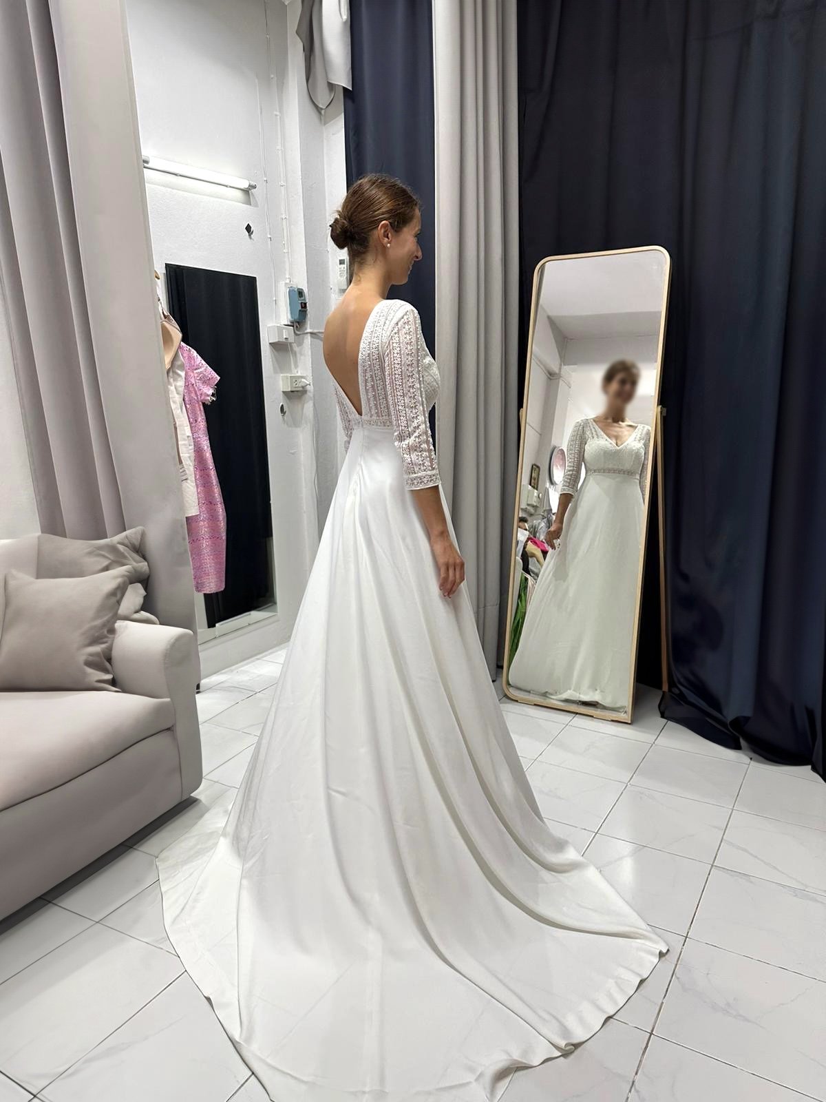 Elegant white wedding gown with lace overlay and a train